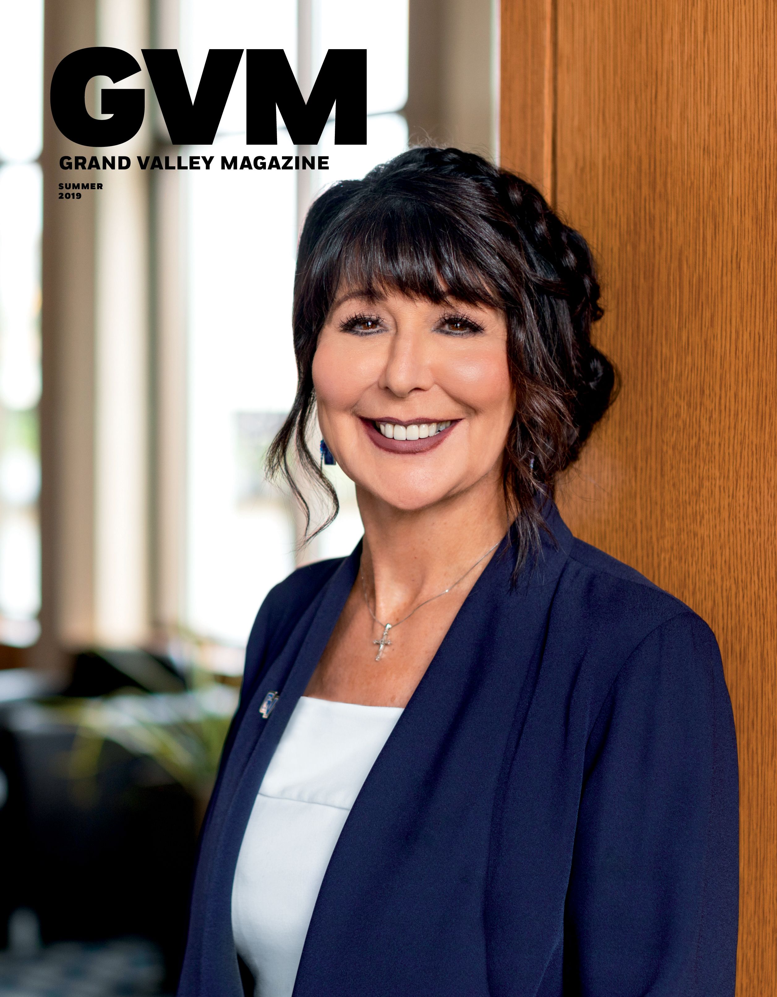 president of GVSU Philomena V. Mantella, standing and smiling at the camera