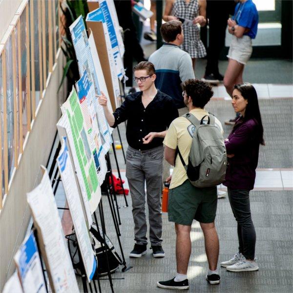 A student discusses his research during Student Scholars Day