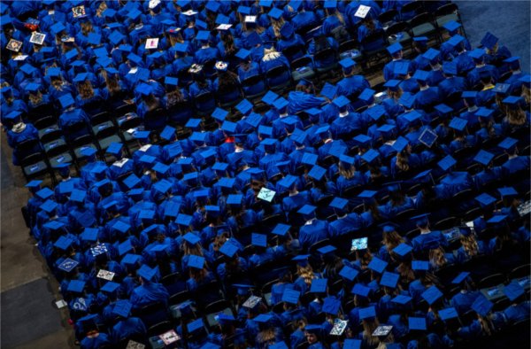 Graduates sit at Van Andel arena during the fall 2023 commencement ceremony.