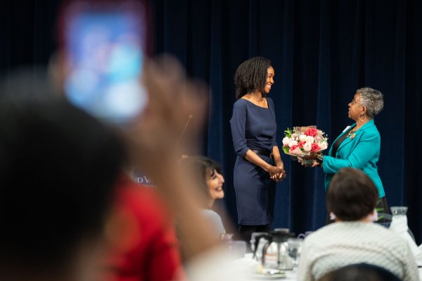 Lisa Norris elementary education placement specialist, presents Bolden with flowers on behalf of Alpha Kappa Alpha Sorority, Theta Chi Omega Chapter. Norris the chapter's second vice president.