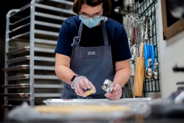 Stir It Up Bakery employee Jessie Cutter shapes cookie dough.