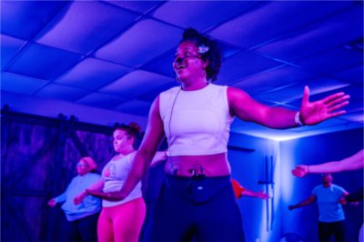 Valarie James, '10, owner of VSJ Fitness, leads a fitness class from a studio. James participated in the Michigan SBDC Pitch Black Competition in 2023 and earned the People's Choice Award plus a $500 prize.