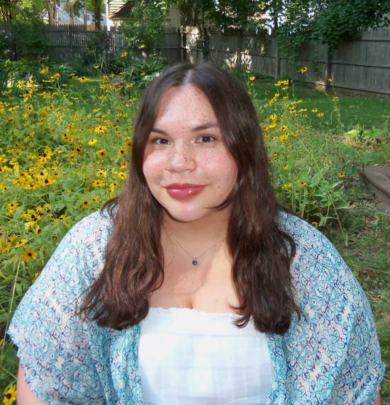 photo of woman with yellow flowers in the background