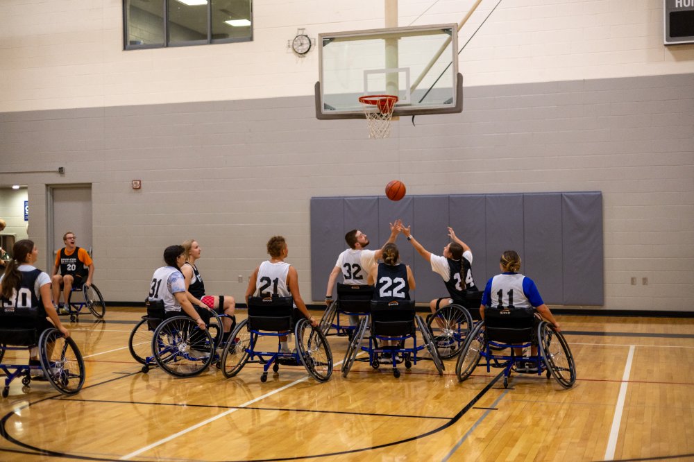 Students participating in a wheelchair basketball adaptive intramural sports event