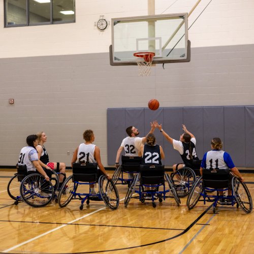 Students participating in a wheelchair basketball adaptive intramural sports event