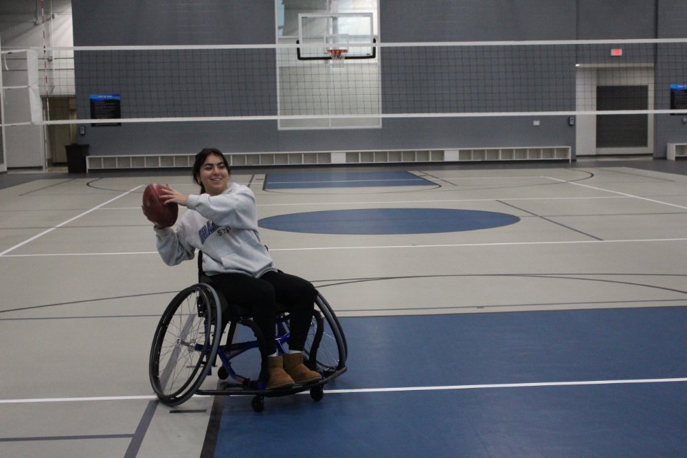 Student participating in wheelchair football at an adaptive intramural sports event.