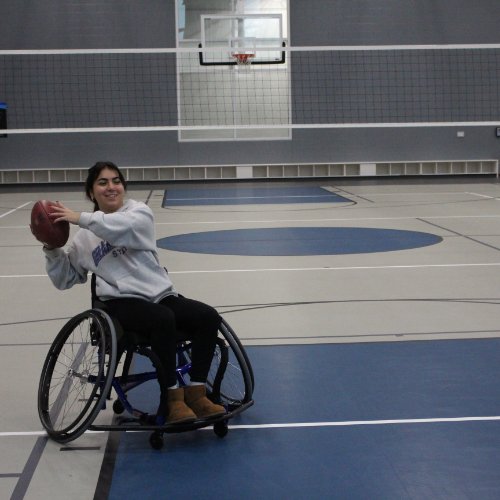 Student participating in wheelchair football at an adaptive intramural sports event.