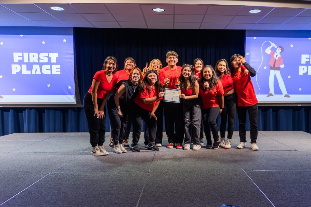 First place winners of last year's lip sync battle posing as a group and smiling holding their first place certification.