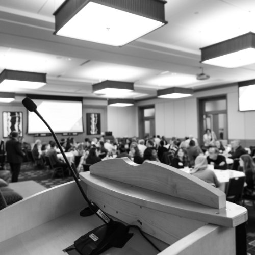 black and white photo of a microphone and podium at an event