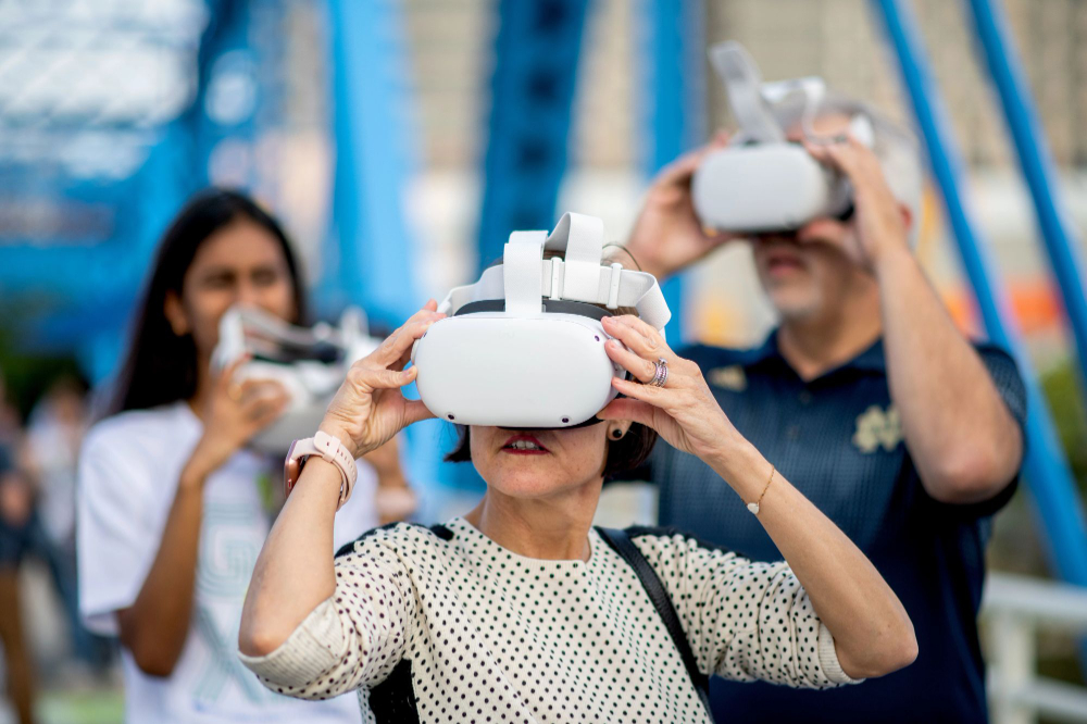 people on Blue Bridge looking through virtual reality headsets