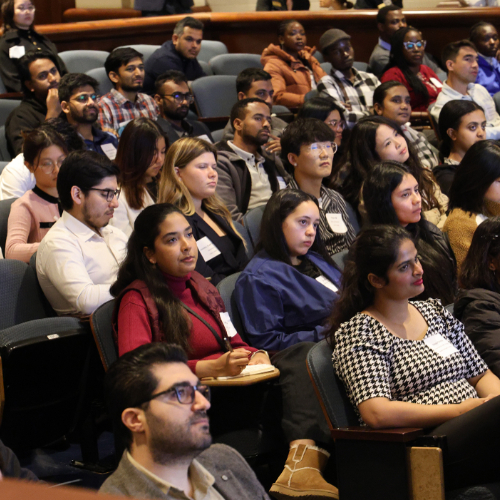 students seated in Loosemore Auditorium listening to presentations