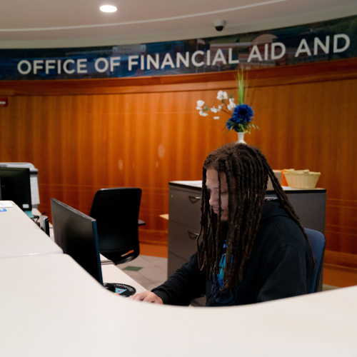 student employee at front desk in the Office of Financial Aid