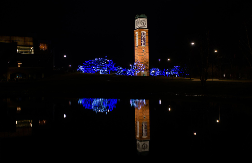 carillon tower at night reflected in Zumberge Pond