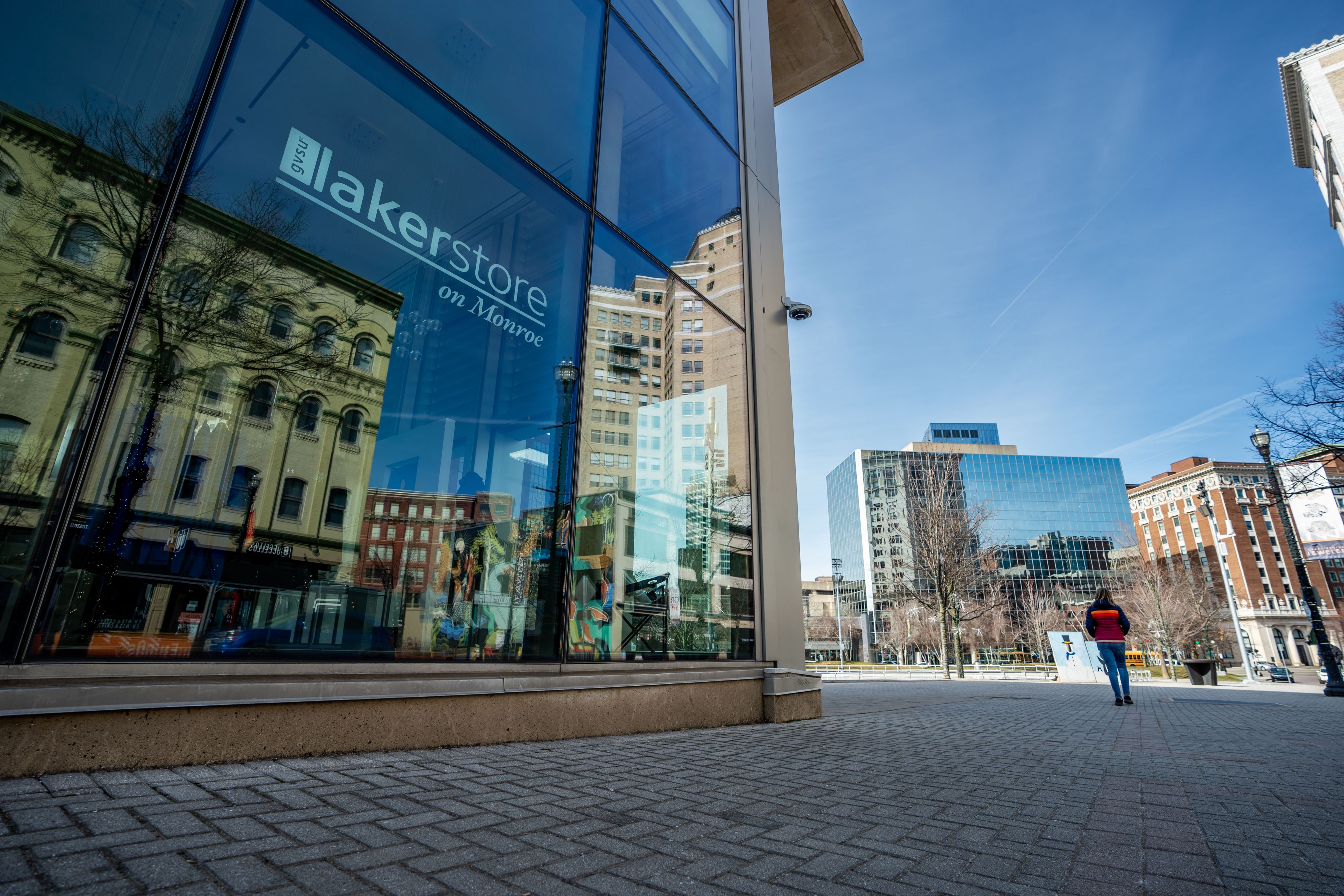 store front with Laker Store on Monroe in white letters, downtown Grand Rapids in backgroudn