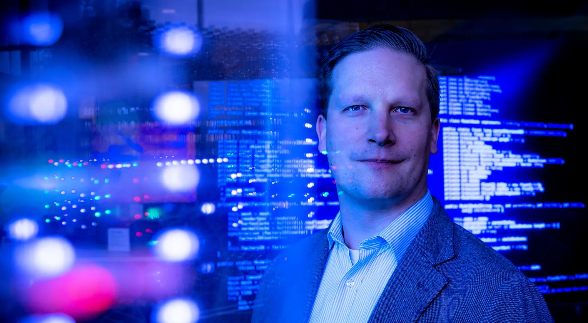 Josh Yavor ’06 is in the forefront with computerized graphics in blue behind him