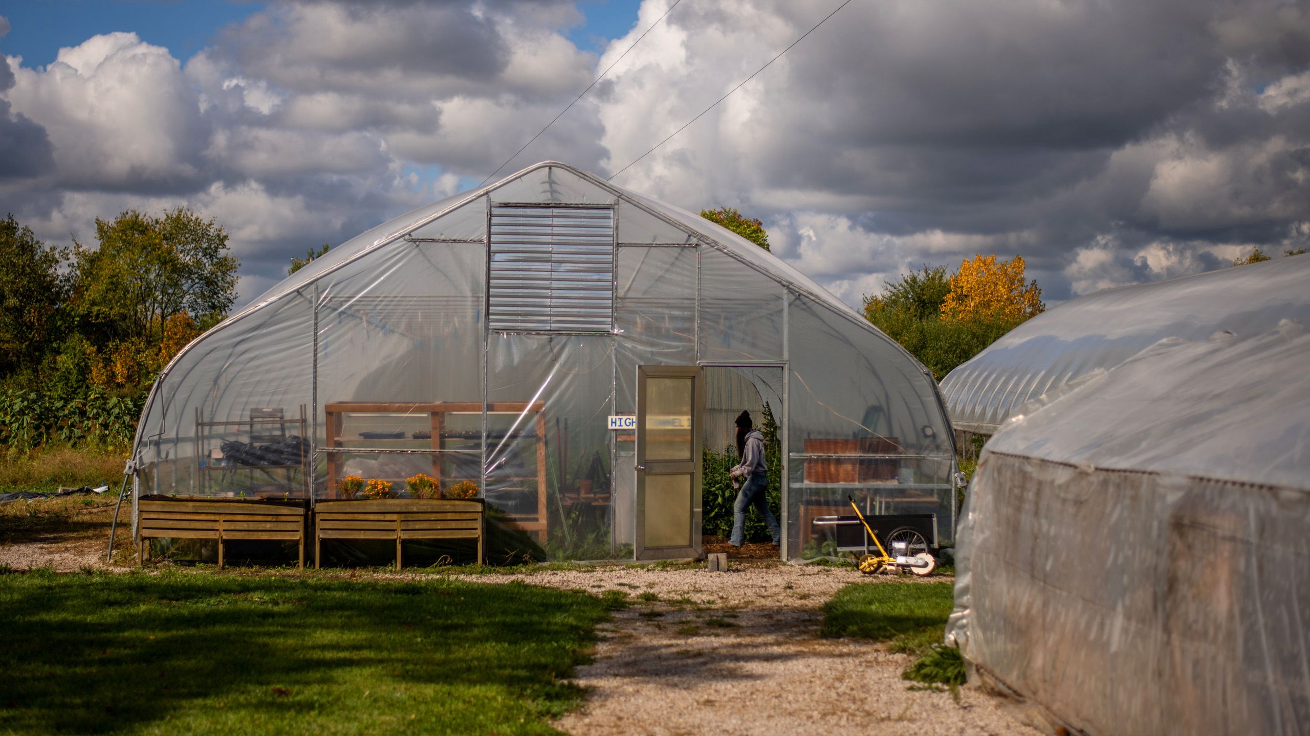 greenhouse with student walking in doorway