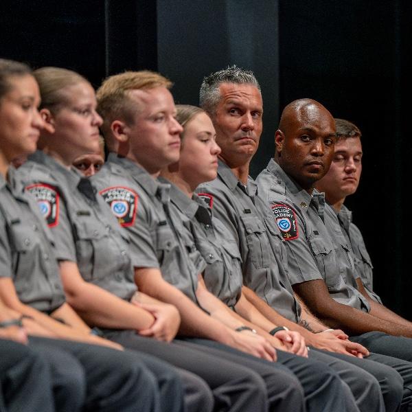 GVSU Police Academy recruits sit at their graduation ceremony.