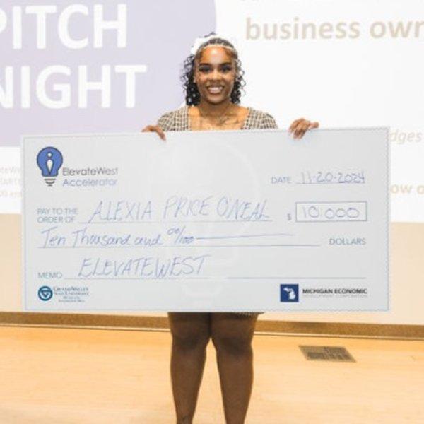 Alexia Price-O'Neal poses for a photo with her first-place check for $10,000