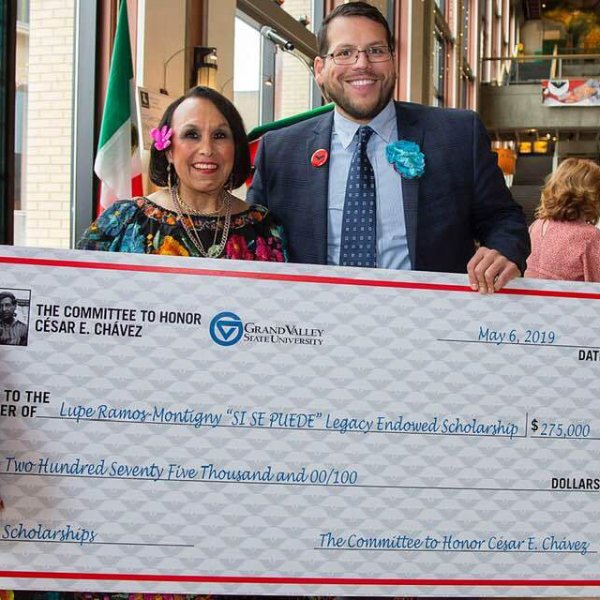 Lupe Ramos-Montigny, chair of the Committee to Honor César E. Chávez, and Jesse Bernal hold a big check at a previous Chavez community event.