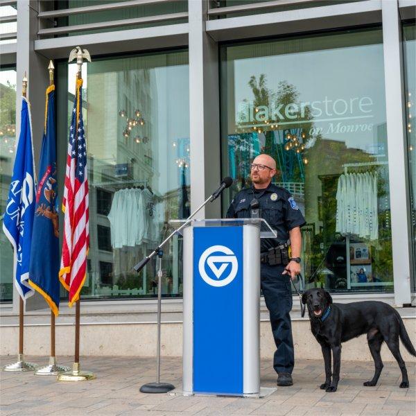 Grand Valley Police Department Officer Paul Weaver with Scout, the new black Labrador K9 police dog, during a press conference.