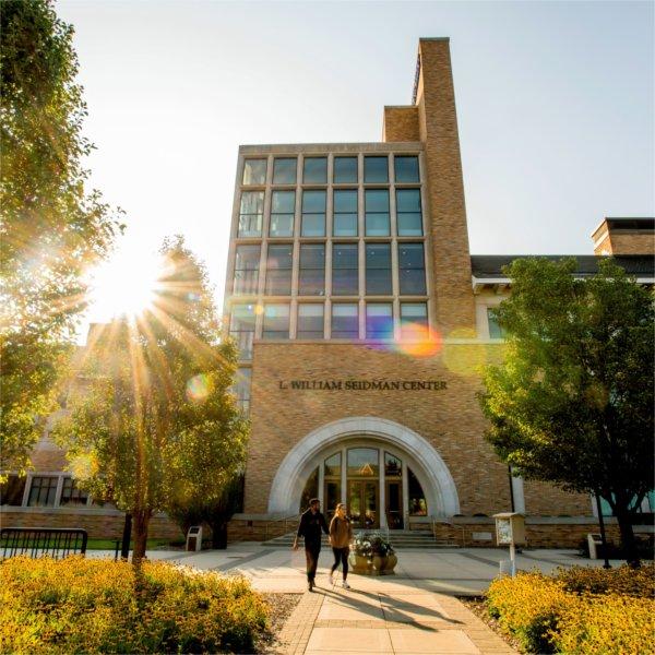 Photo of L. William Seidman Center exterior as students walk by