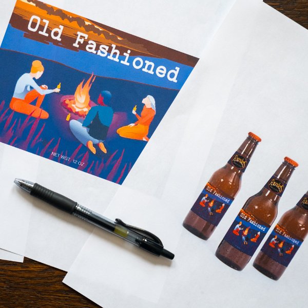 illustrations of a beer bottle label, says Old Fashioned and has illustrated people around a campfire