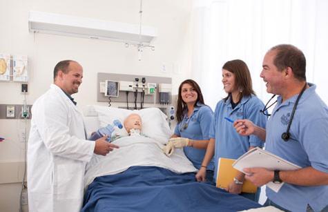 Doctor of nursing practice students are pictured a simulation room in the Cook-DeVos Center for Health Sciences. The degree program recently earned accreditation from the CCNE.