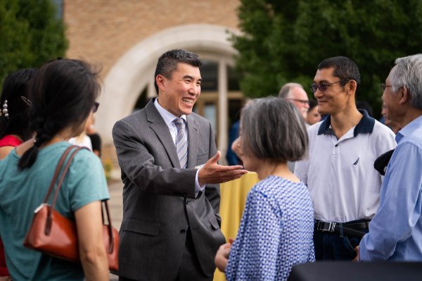 CHP Dean Dr. Jackie Zhang jokes with fellow faculty members