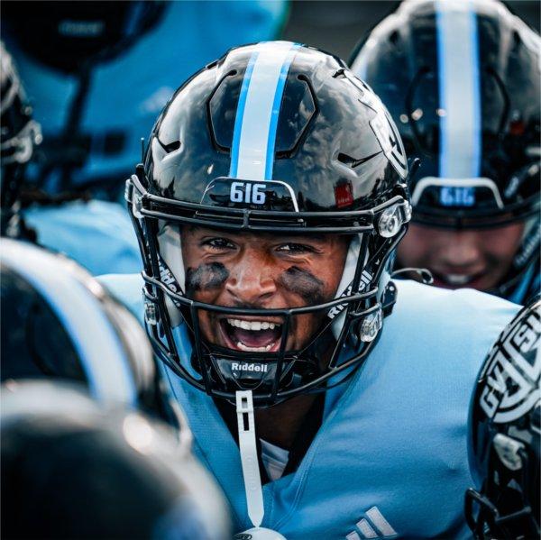 A Lakers football player fires up his teammates before the start of a game.