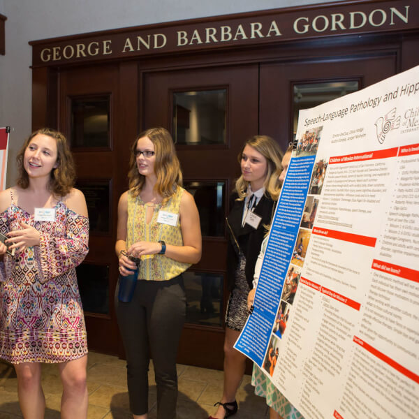 A student explains her research during the 2017 Global Health Showcase.