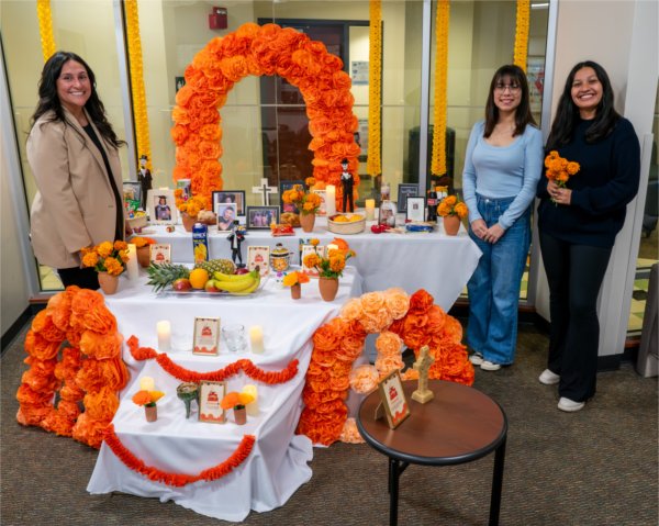 (From left) Thalia Guerra-Flores, Lucero Arizaga and Jackelyn Palmas, pose for a picture with the Día de Muertos (Day of the Dead) altar.