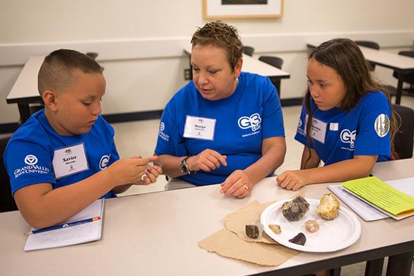 Campers examining rocks and minerals. Photo by Valerie Wojciechowski