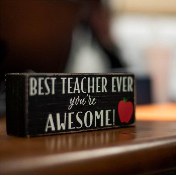 Closeup of sign on teacher's desk that reads "Best Teacher Ever. You're Awesome!"