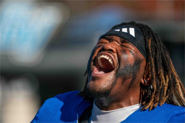  A football player yells while getting ready to begin a game.