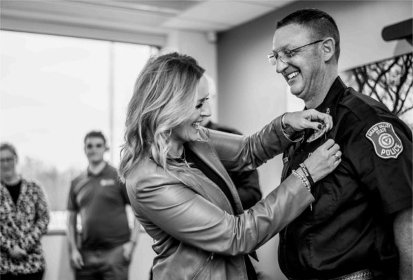  A member of the GVSU Police receives a badge during a swearing-in ceremony.