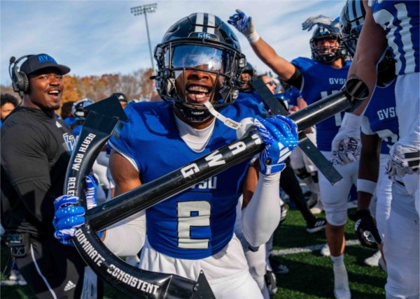  A member of the football team holds an anchor while celebrating a play.