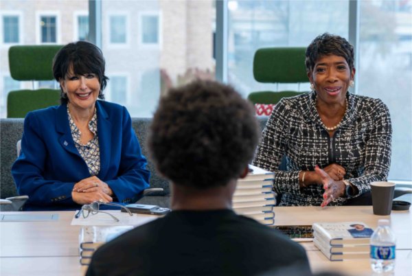  President Philomena V. Mantella and Carla A. Harris speak to students.