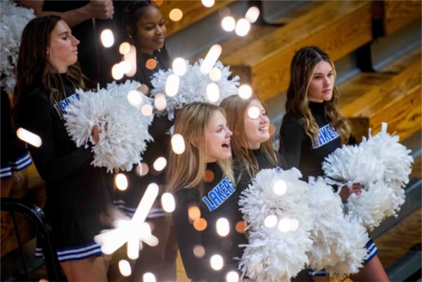  Cheerleaders perform near festive sparks.