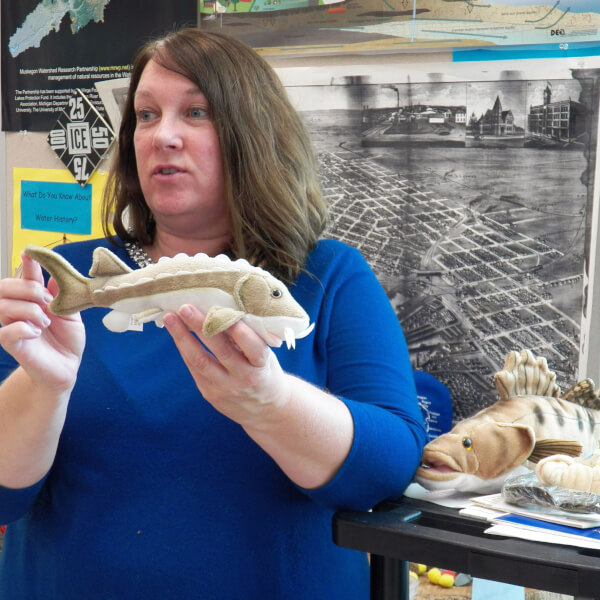 Sherry Claflin holds a stuffed fish while teaching a lesson in a classroom at AWRI.