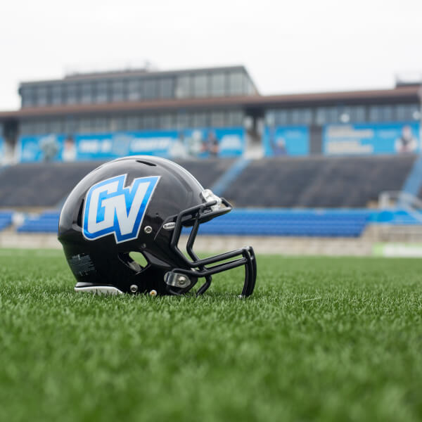 A Grand Valley football helmet sitting on the turf at Lubbers Stadium.
