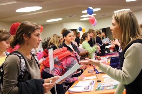 Rebecca Hambleton, director of Study Abroad and International Partnerships, talks with students during a recent study abroad fair. Students can visit the fair Tuesday to browse international programs and meet past participants.
