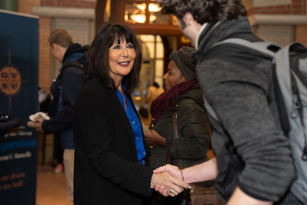 President Mantella shakes the hand of a student
