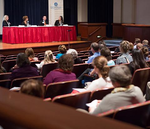 At left, Jean Nagelkerk, vice provost for Health, listens to panelists at a WMIPEI conference. This year�s conference is set for September 18-19.