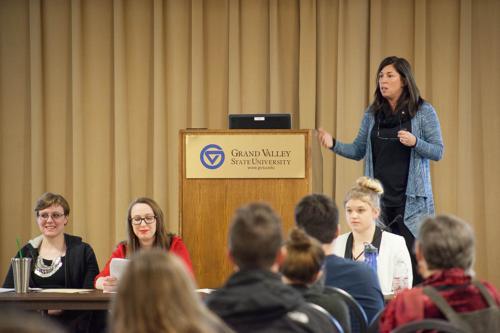 Jamie Owen-DeSchryver, associate professor of psychology, gives a presentation during the Teach-In January 21. Seated from left are students Arielle Perreault, Holly Miller and Olivia Sowa.