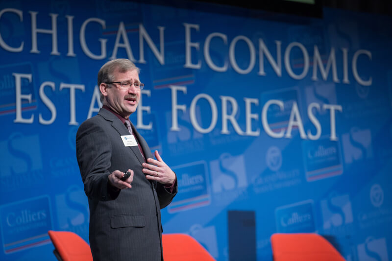 Paul Isely presents his economic forecast on stage.