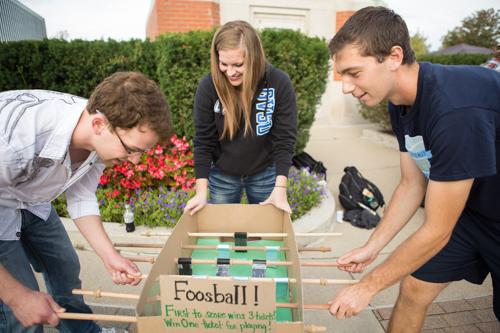 Students play cardboard foosball during the Cardboard Challenge October 4.