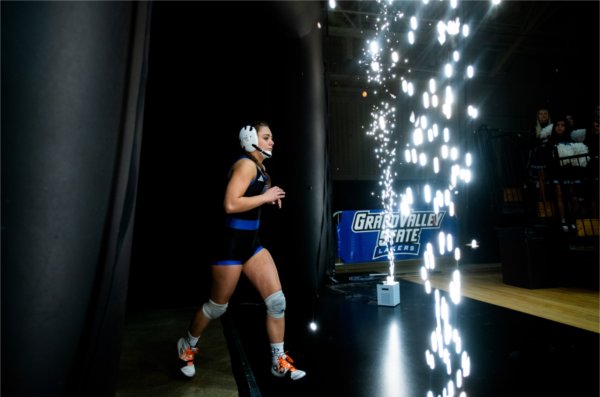 A GVSU wrestler emerges from the locker room for her match.