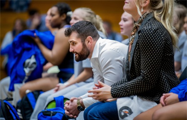 Head coach Jake Short watches one of his wrestlers compete against an opponent from Northern Michigan. 