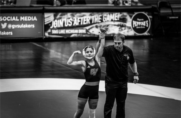 A GVSU wrestler celebrates her forfeit win.