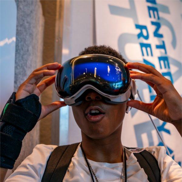 A person reacts to wearing virtual reality googles.